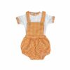 Balloon style baby bib style romper with a orange and white checkered print with suspenders and a white top with orange checkerd trim on the short sleeves and neck line on a white background.