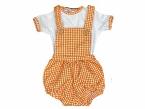 Balloon style baby bib style romper with a orange and white checkered print with suspenders and a white top with orange checkerd trim on the short sleeves and neck line on a white background.