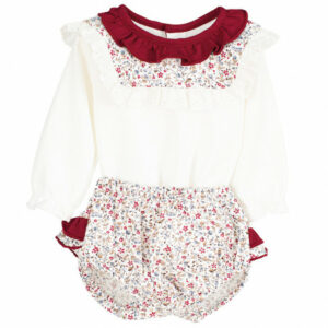 A beautiful infant cream colored top vintage looking, long sleeve, frilly maroon colored neckline blouse. Multi flowered knickers with two layers of ruffles. Also comes with a floral print detachable frilly collar on a white background.