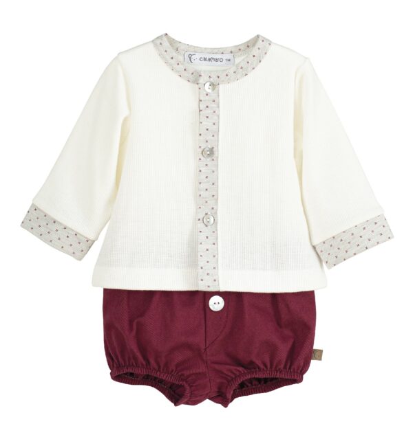 Infant boys cream colored long sleeved top with a maroon floral patterned trim on the neck, wrists and buttoned down front with maroon colored jam pants with button on a white background.