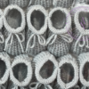 A collage of gray knitted newborn baby booties.