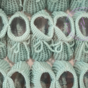 A collage of sage green knitted newborn baby booties.