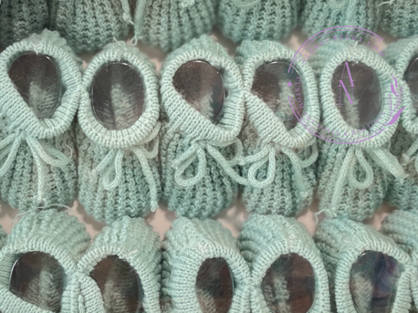A collage of sage green knitted newborn baby booties.