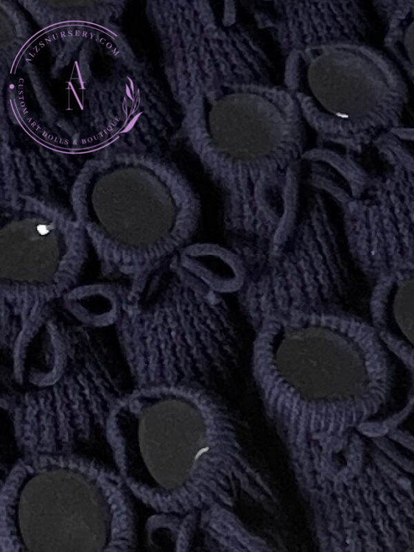 A collage of navy blue knitted baby booties