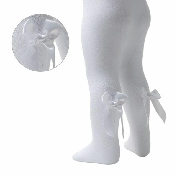 Toddler's legs dressed in white chevron tights with a satin bow attached to the calf.