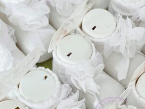 A collage of white newborn baby socks on fitted foot display