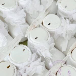 A collage of white newborn baby socks on fitted foot display