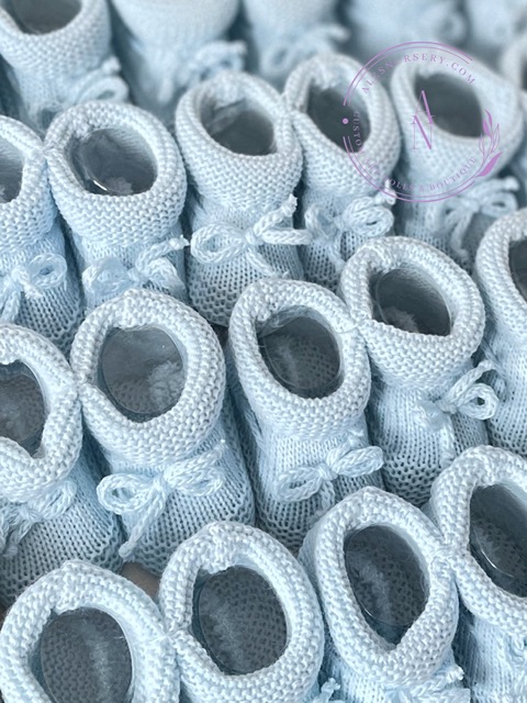 A collage of newborn baby blue spanish style knitted baby booties with a turned down cuff and bow.