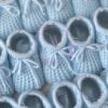 Baby blue colored knitted newborn baby booties made in Spain, sold by Alz's Baby Boutique