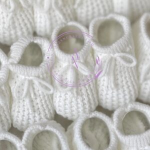Soft fresh white colored knitted newborn baby booties made in Spain, sold by Alz's Baby Boutique