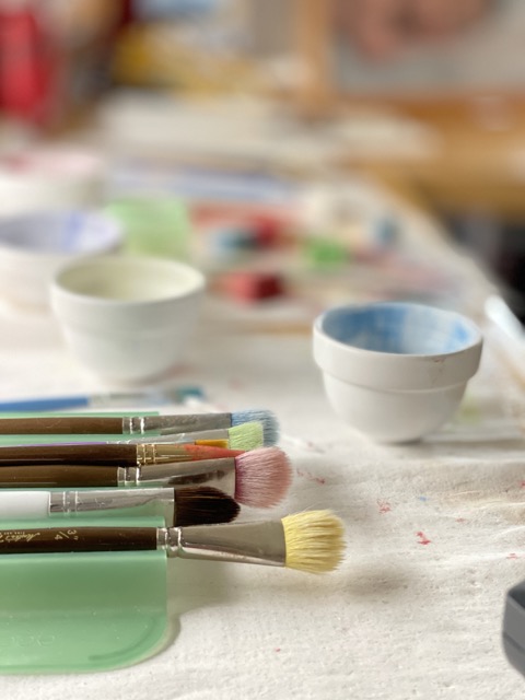 Art table with a wide variety of colors and brushes.