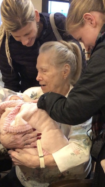 Three generations altogether surprising grandma with a therapy reborn doll.