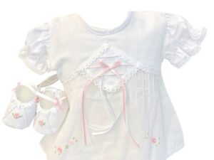 This sweet 3pc white with pink baby set has absolutely beautiful embroidered pink flowers with pearl details with elegant white lace and design on bodice with a cute pink satin ribbon bow. The dress has dainty puffed and gathered short sleeves with eyelet trim. Includes adorable matching bloomers and baby shoes. 65% polyester 35% cotton Made in Columbia Size- Preemie, Newborn