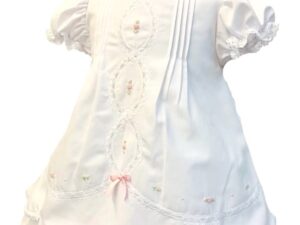 This baby heirloom dress is so incredibly sweet! Having the most beautiful white and pink delicate trim with scalloped  lace border throughout the entire dress with puffed gathered and ruffled short sleeves. This beautiful gown has the most intricate and dainty embroidered flowers and lace border with rows of pin tucks and sewn in seed pearls, a beautiful bow on the back and fully lined. This dress is absolutely priceless and will be a treasure for generations to come. 65% polyester 35% cotton Made in Columbia Size- Newborn Sold by Alz's baby Boutique
