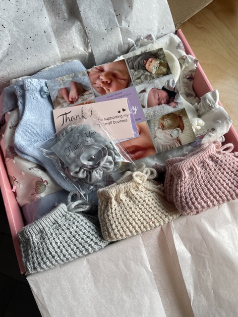 A beautiful baby package from Alz's Baby Boutique packed with adorable baby blue, tan, rose colored booties, socks and all sorts of goodies.