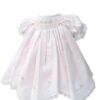 This is an absolutely precious white with pink scalloped dress with the daintiest embroidered white pink flowers over the smocking. This adorable baby dress has gathered puffed and ruffled short sleeves. Trimmed with the sweetest white lace scallop border, pink and white satin bow details. The most precious and elegant rows of pin tucks make this dress simply stunning. 65% polyester 35% cotton Made in Columbia Size- Preemie Sold by Alz's Baby Boutique