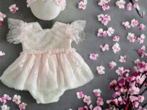 This newborn baby girls princess photography set is absolutely dreamy with the delicate lace, scalloped trim, pink ruffled short sleeves, and headband. A perfect set for your baby's newborn photography shoot! Size- Newborn Sold by Alz's Baby Boutique