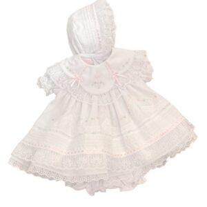 This set is beyond beautiful! This baby girls heirloom dress set, has layers upon layers of intricate and delicate lace trim weaved with gorgeous pink silk ribbons. This little dress has stunning embroidered flowers in pink and white, with tiny white seed pearl accents. This sweet dress has a scalloped lace trimmed collar with puffed and gathered short sleeves. This dress is fully lined with matching bloomers and the sweetest bonnet. 65% polyester 35% cotton Made in Columbia Size- Preemie, Newborn Sold by Alz's Nursery.com