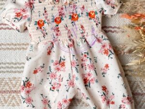 This is one adorable baby romper with the gathered short sleeves, ruffled collar, ankles and smocked style front. The beige floral print has beautiful shades of peach, rose, green and pink. Perfect for any occasion. Size 6m, 18m Sold by ALz's Baby Boutique