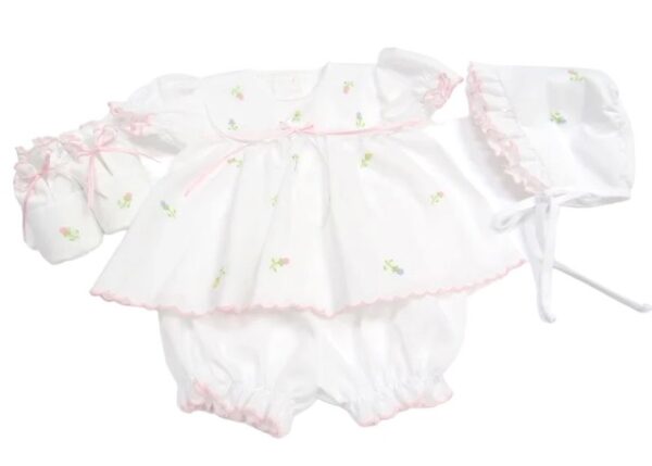 This sweet four piece white dress with multi color flowers includes a stunning dress, bloomer, bonnet and baby shoes. All with embroidered pastel color flowers with individual stems. Has a delicate satin ribbon inserted in a white lace white ribbon bow accent. Pink scallop border trim with short puffed and gathered sleeves. Comes in sizes preemie and newborn. Made in Columbia Sold by Alz's Baby Boutique