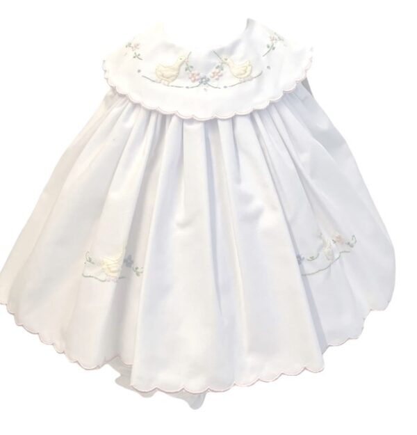 Story book beautiful baby dress has yellow embroidered ducks among pastel color flowers with delicate round collar, dress has scallop border pink trim. Fully lined. Available in sizes Preemie, Newborn Made in Columbia Sold by Alz's Baby Boutique