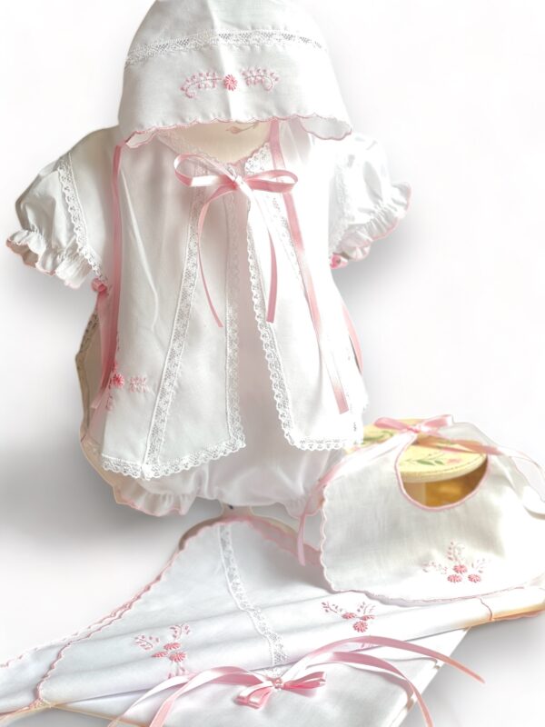 This adorable & sweet five piece baby take me home set includes, beautiful dress with short puffed and gathered sleeves, an overlay with embroidered details and elegant white lace insert, satin ribbon details. Matching bonnet & bloomers, bib and elegant matching blanket all inside a tulle sack included. Newborn in size. Made in Columbia Sold by Alz's Baby Boutique