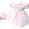 This precious pink and white dress set, has a delicate white sheer poly overlay with embroidered pink flowers with tiny pearl accents over smocking with a pink lining. Delicate white lace trim on sleeves. Peter pan collar with the cutest matching bonnet. Made in Columbia 100% Poly.   Sold by Alz's Baby Boutique.