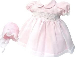 This precious pink and white dress set, has a delicate white sheer poly overlay with embroidered pink flowers with tiny pearl accents over smocking with a pink lining. Delicate white lace trim on sleeves. Peter pan collar with the cutest matching bonnet. Made in Columbia 100% Poly.   Sold by Alz's Baby Boutique.