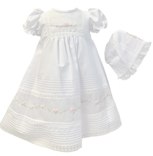 An absolutely beautiful baby gown with delicate embroidered flowers over rows of organza detail, lace inset with delicate lace border trim, has rows of tiny pleated design. Gathered puffed short sleeves trimmed with lace. Fully lined. Includes a matching bonnet. Made in Columbia Poly cotton blend.  Sold by Alz's Baby Boutique